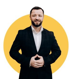 Myron Korostil wearing a dark jacket and white shirt